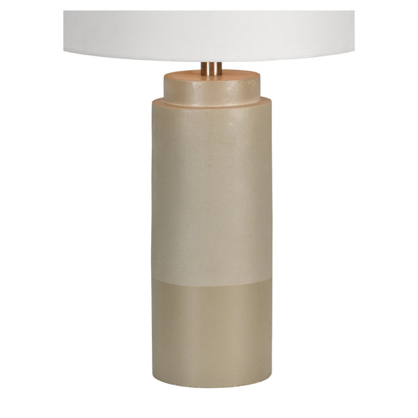 Beige cylinder table lamp with white shade.