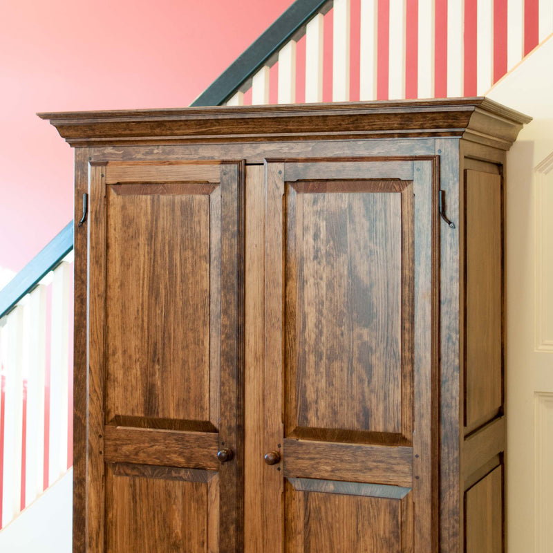 Solid wood raised panel armoire in provincial, angle on, close crop