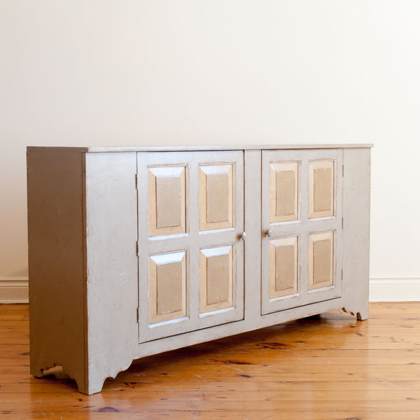 Close up, angle view of pewter sideboard with two quadruple raised panel doors. 