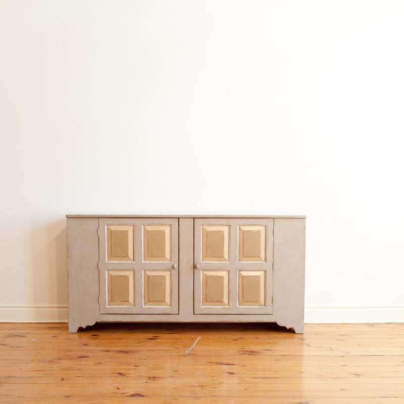 Cropped out view of pewter sideboard with two quadruple raised panel doors. 